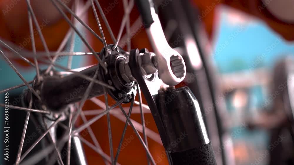 Close-up of female bicycle mechanic assembles a mountain bike and repairs fixing wheel. Maintenance Close-up of female bicycle mechanic assembles a mountain bike and repairs fixing wheel. Maintenance
