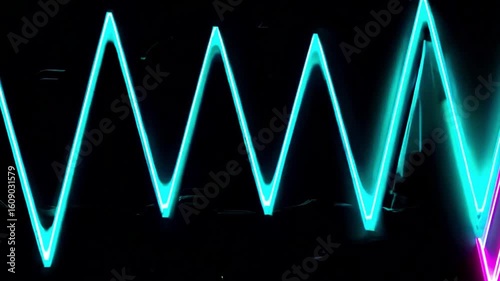 Abstract neon light design in the form of zig-zag waves against a dark background, highlighting the vibrant and modern nature of the artwork