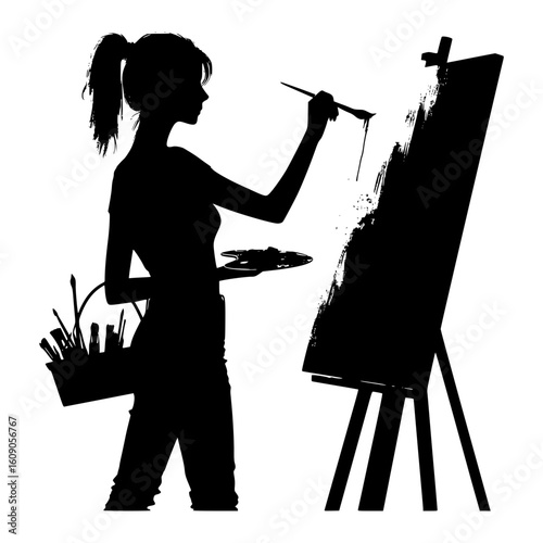 Silhouette of a young woman artist painting on a canvas with a paintbrush