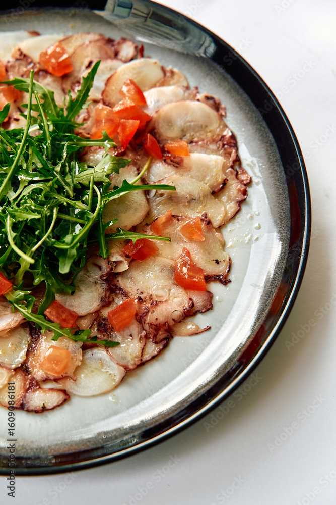 Deliciously Crafted Carpaccio Garnished with Fresh Arugula and Tomato, Showcasing the Art of Culinary Presentation and Flavor Balance in Italian Cuisine Deliciously Crafted Carpaccio Garnished with Fresh Arugula and Tomato, Showcasing the Art of Culinary Presentation and Flavor Balance in Italian Cuisine