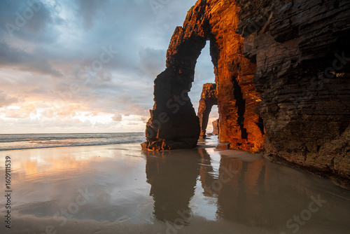 Reflections at sunset at praia das catedrais, galicia, espana
