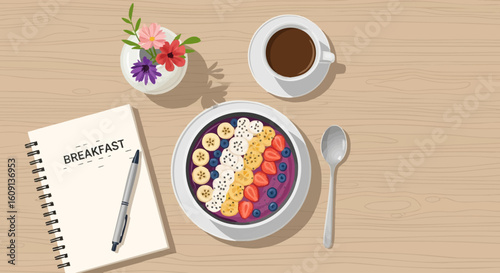 Top view of a healthy breakfast smoothie bowl with fresh fruit, coffee, and a planning notebook.