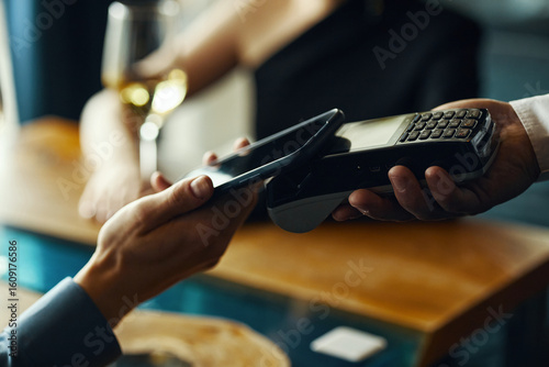 Canvastavla Caucasian young adult man holding smartphone making contactless payment using wi