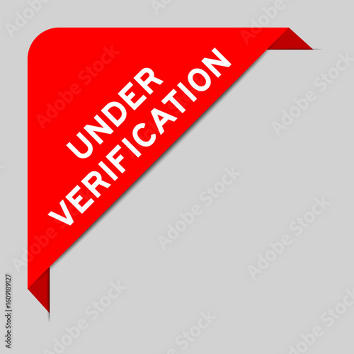Red color of corner label banner with word under verification on gray background