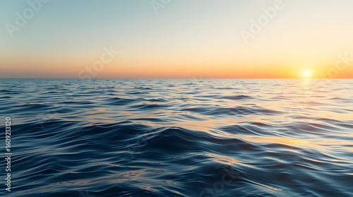 Serene seascape at dusk, capturing the tranquil beauty of the open ocean and the setting sun's warm glow.
