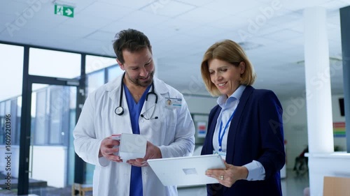 Female medical sales representative presenting medication to doctor