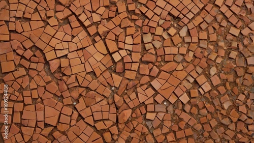 Aerial view of a surface covered in many small irregular terracotta tiles and pieces of terracotta