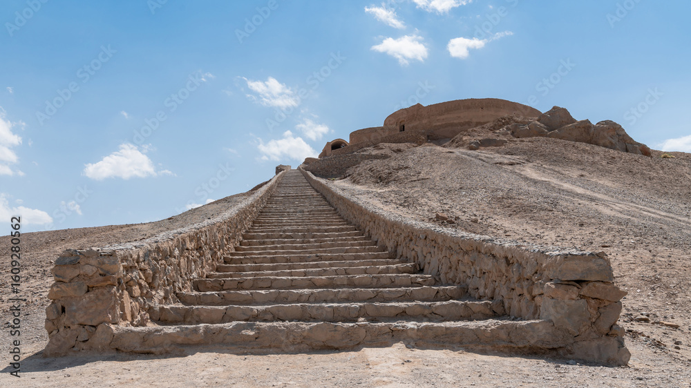 Obraz premium The ancient Zoroastrian Towers of Silence in Yazd, elevated circular structures on arid hills, under a vast sky
