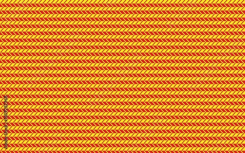 Close up of woven fabric with horizontal stripes of yellow and red threads