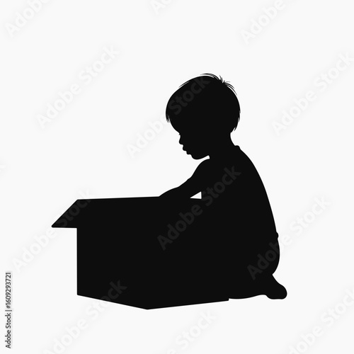 Child playing with cardboard box. Young toddler exploring large cardboard box. Creative playtime concept for children's imagination and development.