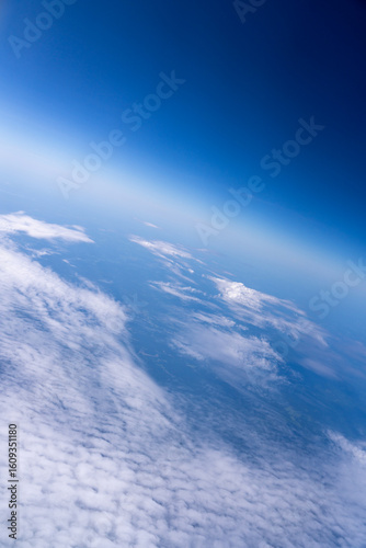 Earth from space, showing clouds and blue atmosphere.