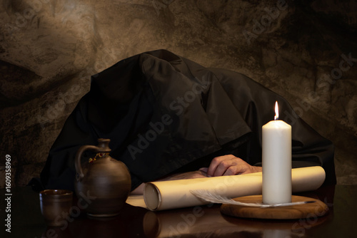 A solitary moment of monastic life by candlelight.