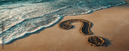 A sandy beach displays a question mark near the ocean's edge, inviting contemplation and reflection on life's mysteries.