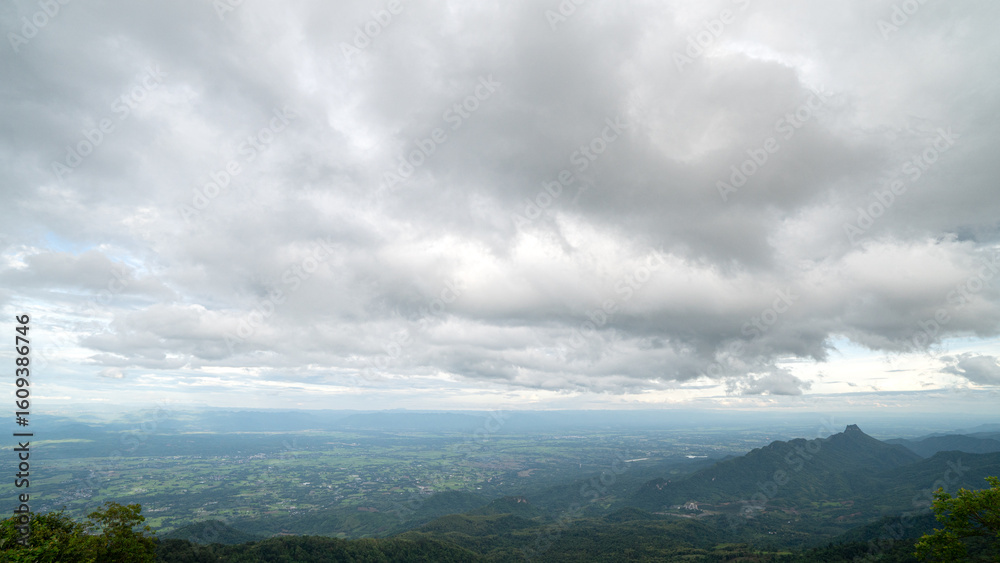 Obraz premium Landscape of a city surrounded by natural mountains. clouds above are dense. Lom Kao city in the morning. At Phu Thap Boek Phetchabun Thailand.