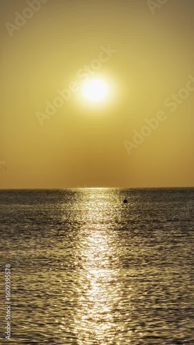 Golden sunrise at the seaside, romantic atmosphere, stunning nature. Vertical 4k footage