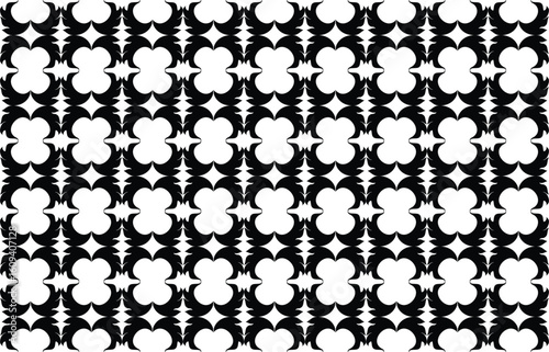 Intricate black and white geometric pattern with repeating quatrefoil and star motifs
