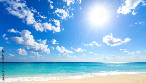 Fototapeta Naklejka Na Ścianę i Meble -  Idyllic tropical paradise beach with a bright sun shining in the blue sky over the calm turquoise sea.