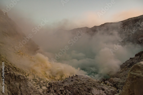 Sunrise image of tourists at Kawah Ijen, a beautiful turquoise crater lake in the stratovolcano Mount Ijen, located in East Java, a province on Indonesia's Java island