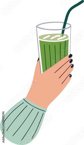 Hand holding green drink with straw glass