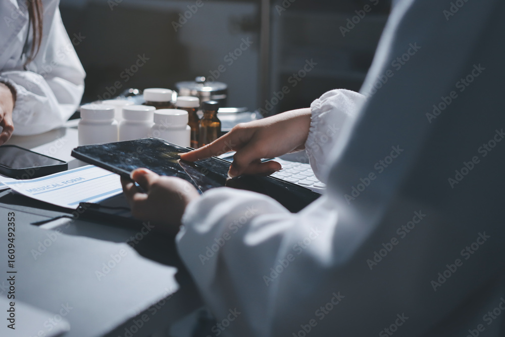 Naklejka premium Male and female doctors are having a meeting in a hospital room.