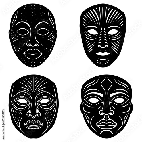 Collection of four black and white african tribal masks with unique designs and facial features displayed