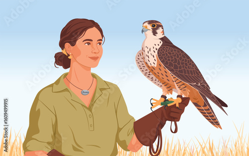 A female falconer holding a majestic peregrine falcon on her leather glove