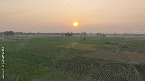 Golden hour drone footage of sunset over mixed agricultural fields in rural Bangladesh