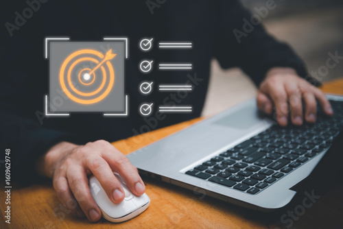Business planning concept and strategic goal setting and with a businessman pointing at a target icon and checklist. Ideal for success, productivity, project execution and leadership content.