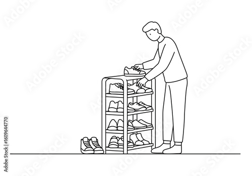 A man neatly organizes his footwear, placing a sneaker onto a multi-level shoe rack.