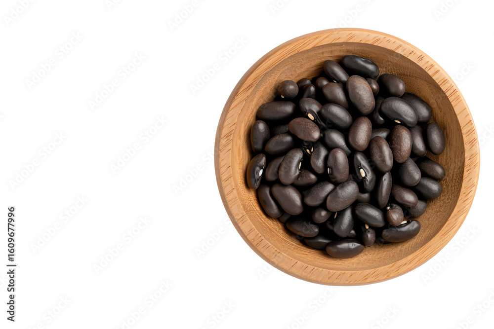 Fototapeta premium A wooden bowl filled with black beans on a white isolate background.