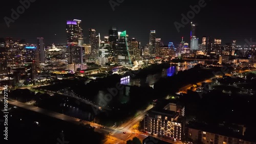 Beautiful Austin downtown skyline at night with a stunning aerial drone view of cars bridge and city