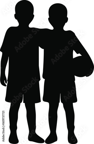 Silhouette of two young boys, friends, with a soccer ball
