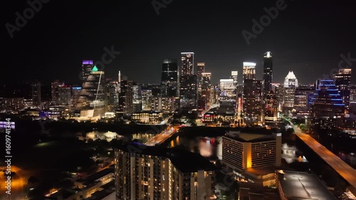 Beautiful Austin downtown skyline at night with a stunning aerial drone view of cars bridge and city