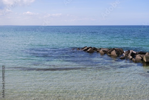 Wallpaper Mural Vom Strand des Ostseebads Wustrow ragt diese Steinbuhne ins Meer. Das Wasser der  Ostsee sieht vor der Halbinsel Fischland türkis aus. Torontodigital.ca