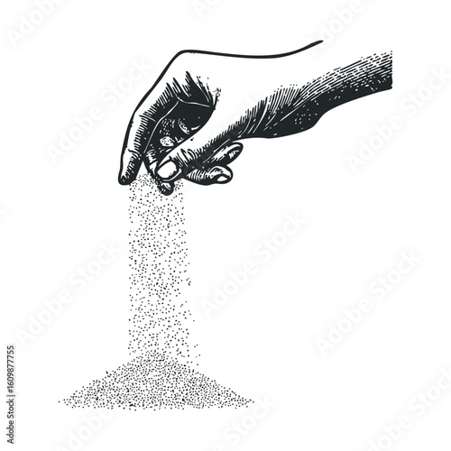 Hand pouring fine sand creating a small mound on a surface