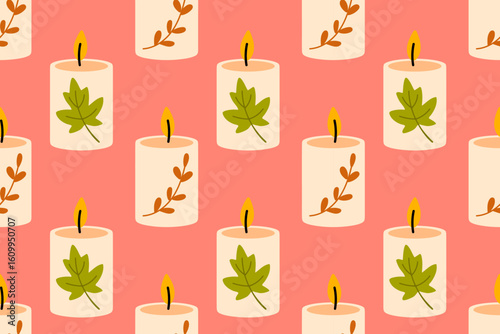 Autumn decorative candles with green maple leaves in repeat design