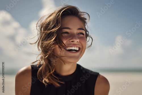 Laughing Woman on Sunny Beach, Wind-Blown Hair, Wearing Black Outfit – High Quality 8K Portrait in Natural Light Conveying Joy and Freedom