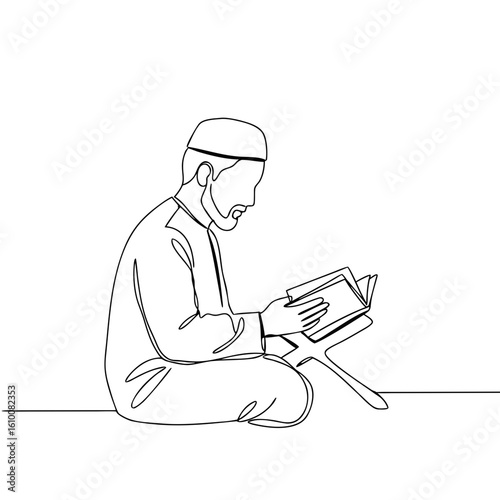 Muslim man reading Quran while sitting on the floor at home  