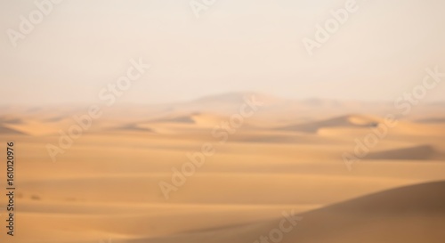 Fototapeta Naklejka Na Ścianę i Meble -  A completely blurry view of vast desert sand dunes, a soft blur landscape at sunrise.