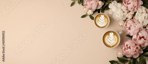 Two cups of coffee with latte art surrounded by pink and white peony flowers beige background creating calm and elegant