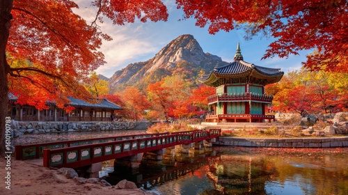 Ancient Korean temple surrounded by autumn maple trees and colorful leaves on water, distant mountain under clear blue sky, peaceful landscape with Goryeo ink-style mood in calm seasonal atmosphere.