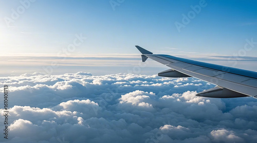 Airplane wing in high-altitude sea of clouds, travel, business trip, transportation scene