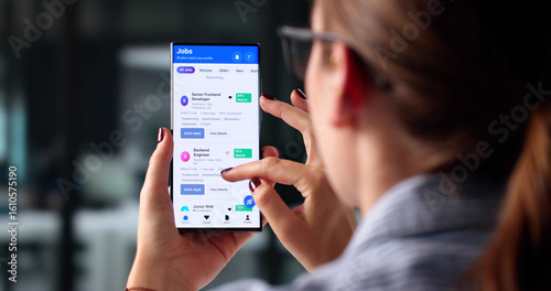 Fototapeta Woman Using Smartphone To Browse Job Opportunities