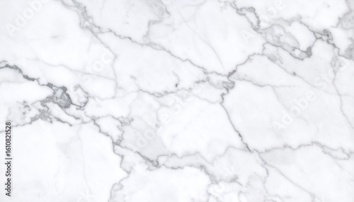 Polished white marble surface with soft gray veining, showcasing a refined and elegant stone texture perfect for modern interiors and luxury design elements.