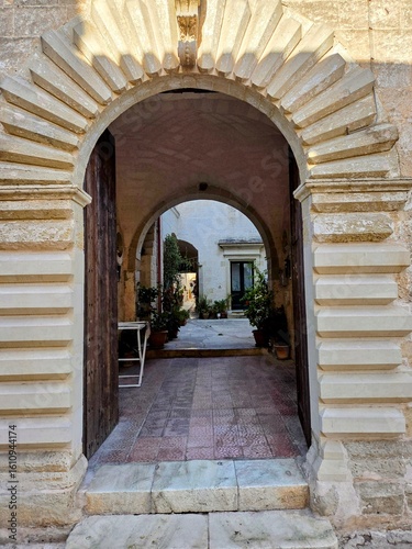 The entrance arch of an old house in the medieval quarter of Galatone, an old town in Puglia, Italy.