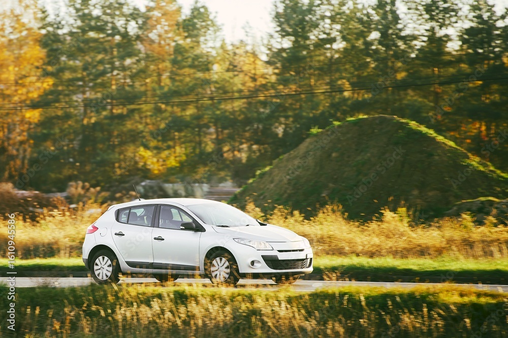 Compact eco-friendly car in autumn nature Compact eco-friendly car in autumn nature