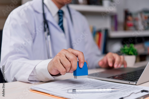 doctor is stamping an important medical document, indicating the confirmation of information, approval of treatment, issuance of a certificate, professional and legal work.