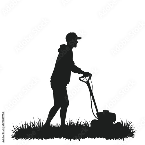 Silhouette of man mowing lawn grass