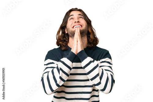 фотографія Young handsome man over isolated background keeps palm together