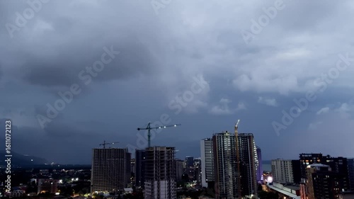 Dramatic Thunderstorm Over City at Dusk with Lightning Strike